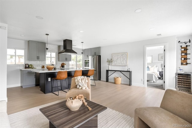 3065 S Eudora St, Denver, CO 80222 - living area with light wood-style floors, beverage cooler, recessed lighting, and baseboards