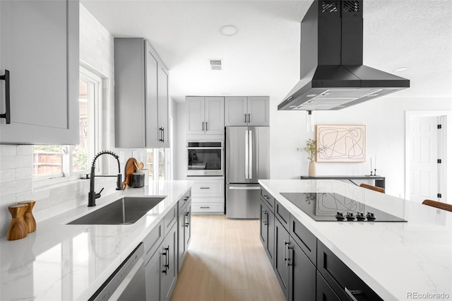 3065 S Eudora St, Denver, CO 80222 - kitchen featuring wall chimney exhaust hood, appliances with stainless steel finishes, a sink, backsplash, and light stone countertops