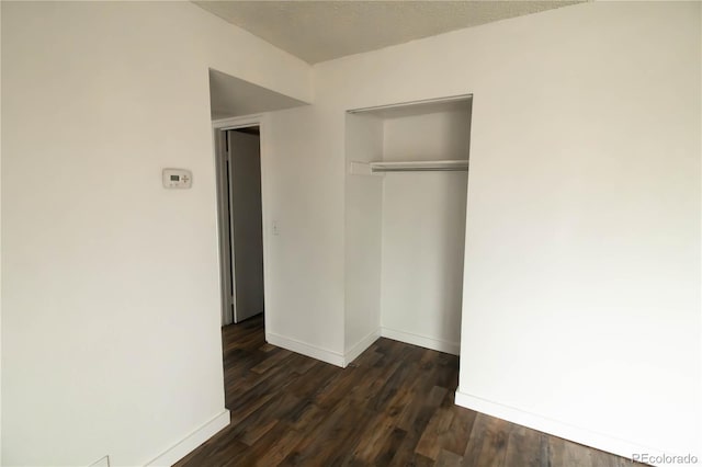 10211 Ura Ln Unit 9-308, Thornton, CO 80260 - unfurnished bedroom with a closet and dark wood-style flooring