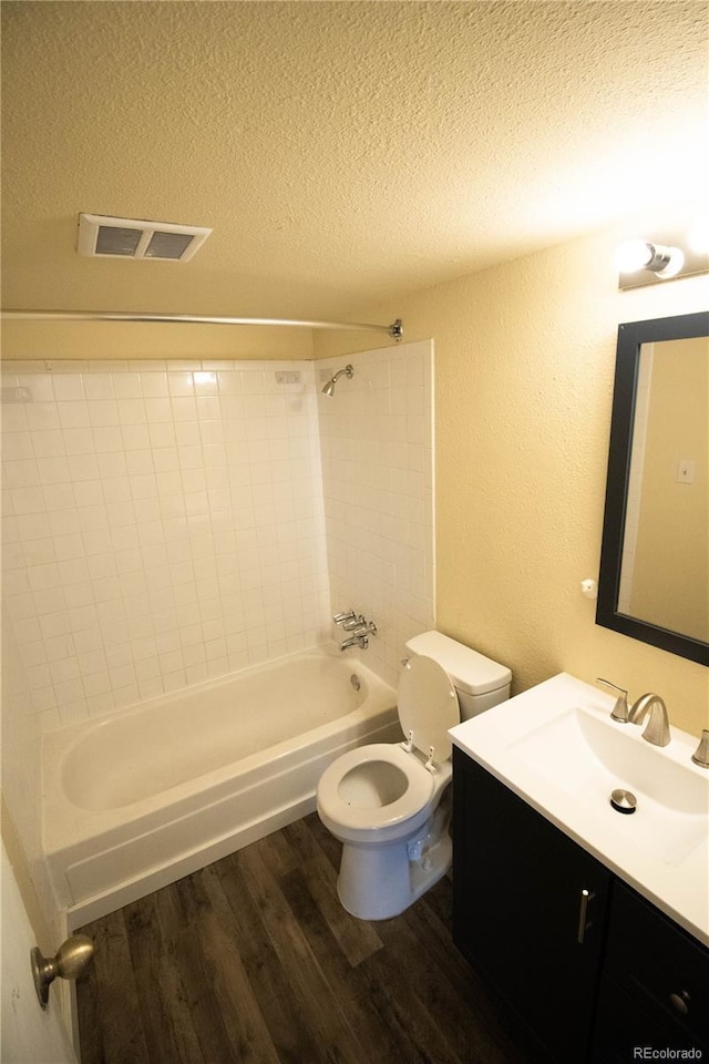 10211 Ura Ln Unit 9-308, Thornton, CO 80260 - full bath featuring wood finished floors, a textured ceiling, vanity, shower / bathtub combination, and a textured wall