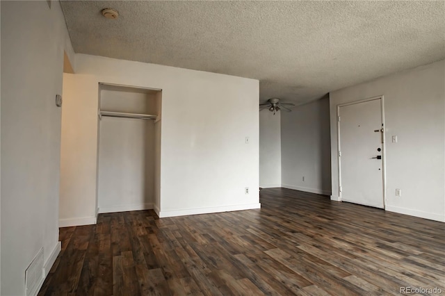 10211 Ura Ln Unit 9-308, Thornton, CO 80260 - unfurnished bedroom featuring a textured ceiling, dark wood-style flooring, and a closet