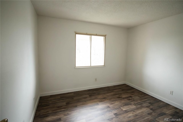 10211 Ura Ln Unit 9-308, Thornton, CO 80260 - unfurnished room with dark wood finished floors and a textured ceiling