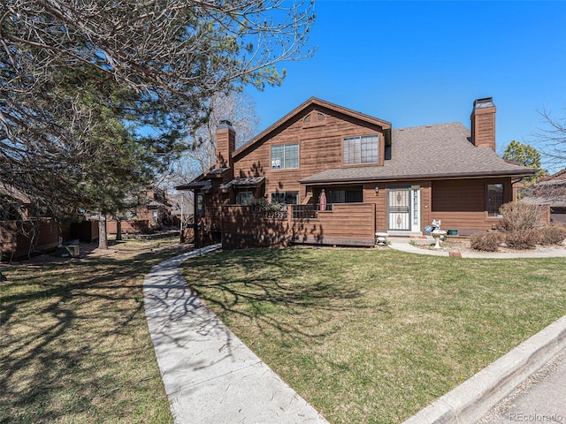 9365 W 80th Pl Unit C, Arvada, CO 80005 - rear view of property featuring a chimney, a yard, and a shingled roof