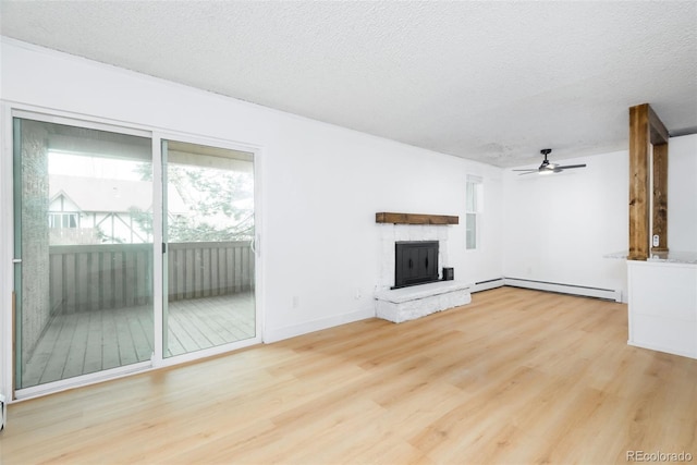 3035 Oneal Pkwy Unit 20V, Boulder, CO 80301 - unfurnished living room with a ceiling fan, wood finished floors, baseboard heating, a fireplace, and a textured ceiling