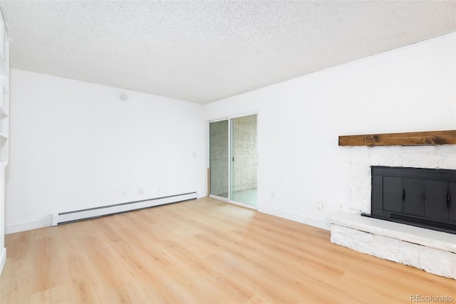 3035 Oneal Pkwy Unit 20V, Boulder, CO 80301 - unfurnished living room featuring a baseboard heating unit, wood finished floors, a fireplace, a textured ceiling, and baseboards