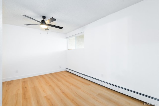 3035 Oneal Pkwy Unit 20V, Boulder, CO 80301 - spare room featuring a baseboard heating unit, wood finished floors, ceiling fan, baseboards, and a textured ceiling