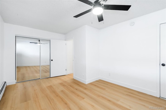 3035 Oneal Pkwy Unit 20V, Boulder, CO 80301 - unfurnished bedroom with light wood finished floors, baseboards, ceiling fan, and a baseboard radiator