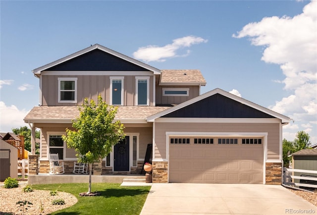 101 Wake St, Frederick, CO 80530 - craftsman-style home featuring stone siding, board and batten siding, concrete driveway, and covered porch