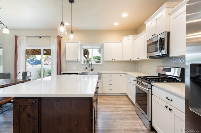 101 Wake St, Frederick, CO 80530 - kitchen with stainless steel appliances, light countertops, recessed lighting, light wood-type flooring, and tasteful backsplash