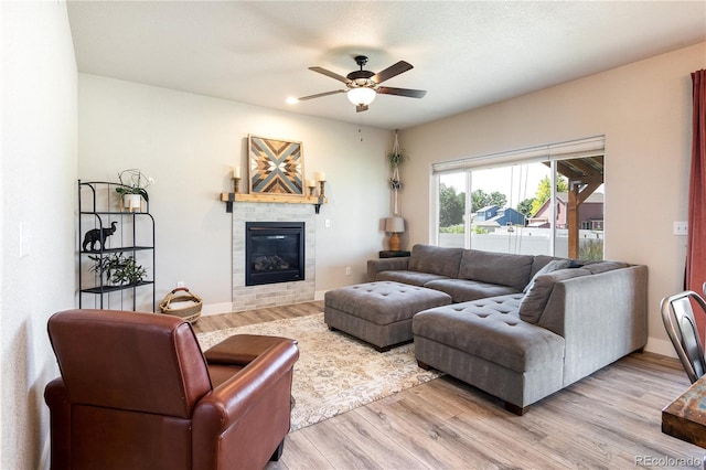 101 Wake St, Frederick, CO 80530 - living area with ceiling fan, a glass covered fireplace, and light wood-style floors