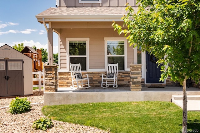101 Wake St, Frederick, CO 80530 - entrance to property featuring roof with shingles, stone siding, and board and batten siding