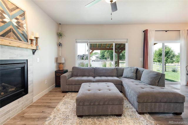 101 Wake St, Frederick, CO 80530 - living area featuring wood finished floors, a tile fireplace, and a ceiling fan