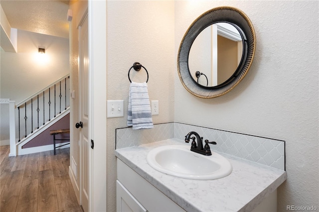 101 Wake St, Frederick, CO 80530 - bathroom featuring tasteful backsplash, wood finished floors, and vanity