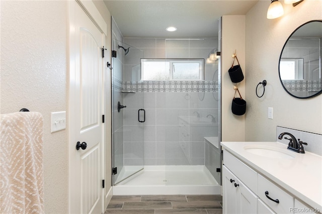 101 Wake St, Frederick, CO 80530 - bathroom featuring a stall shower, vanity, and wood finish floors