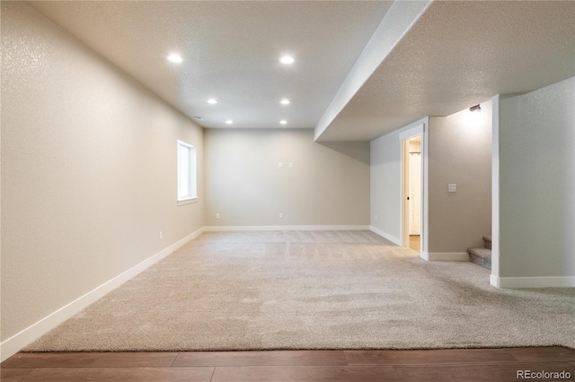 101 Wake St, Frederick, CO 80530 - below grade area featuring light colored carpet, recessed lighting, stairs, and light wood-style floors
