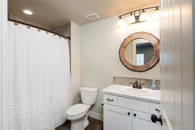 101 Wake St, Frederick, CO 80530 - bathroom featuring vanity, wood finished floors, a textured ceiling, and curtained shower