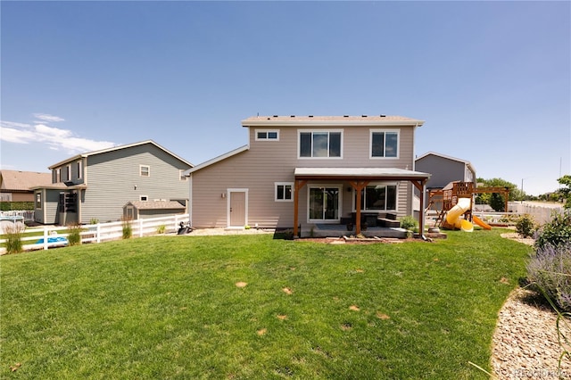 101 Wake St, Frederick, CO 80530 - rear view of house featuring a playground, a fenced backyard, and a patio area