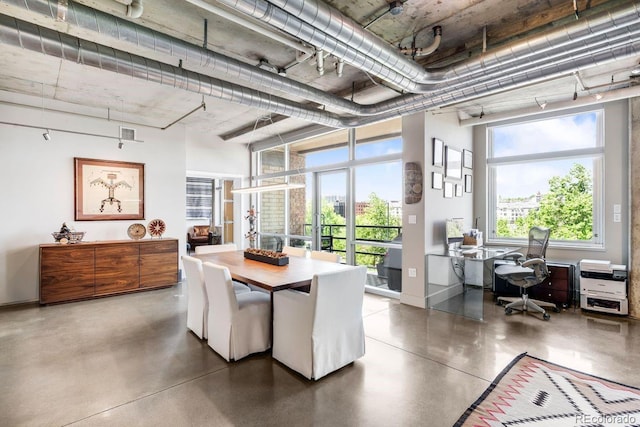 1610 Little Raven St Unit 302, Denver, CO 80202 - dining area featuring a desk, concrete floors, and baseboards