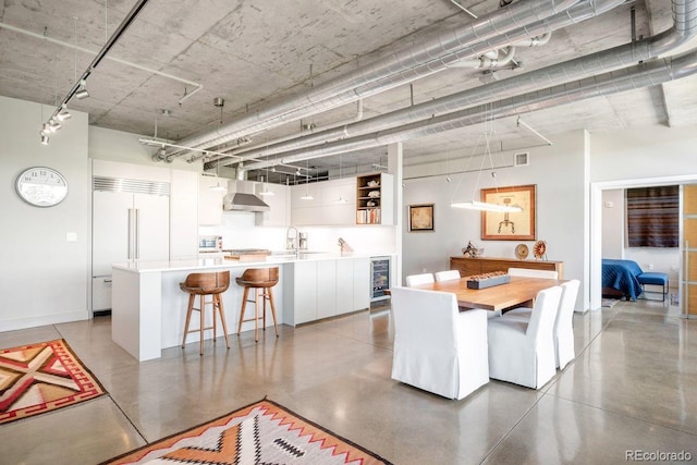 1610 Little Raven St Unit 302, Denver, CO 80202 - dining area featuring wine cooler and concrete floors