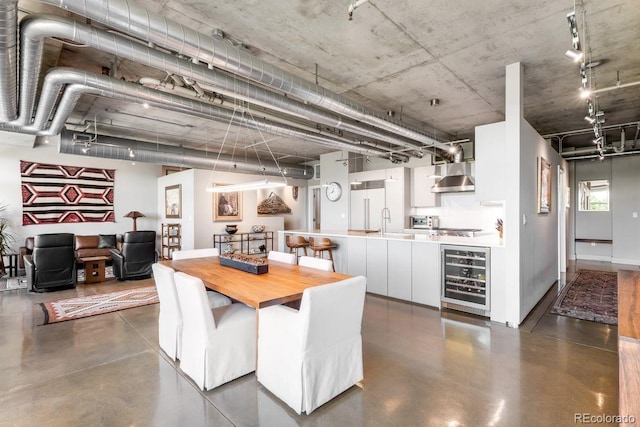 1610 Little Raven St Unit 302, Denver, CO 80202 - dining room with wine cooler, concrete flooring, and rail lighting