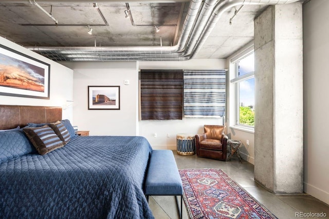 1610 Little Raven St Unit 302, Denver, CO 80202 - bedroom featuring baseboards, finished concrete flooring, and rail lighting