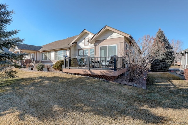 back of house featuring a yard and a wooden deck