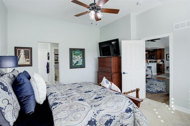 bedroom with ceiling fan, visible vents, and wood finished floors