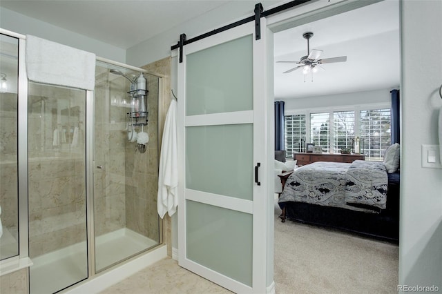 ensuite bathroom with a stall shower, a ceiling fan, and ensuite bathroom