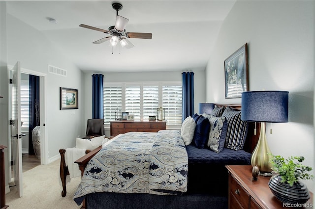 bedroom with lofted ceiling, multiple windows, visible vents, and light colored carpet