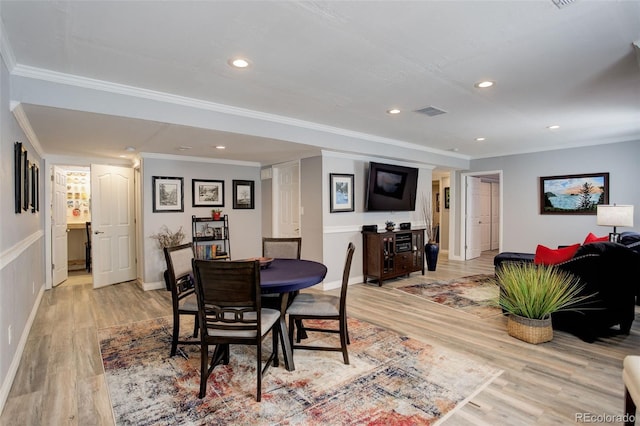 dining room with light wood-style flooring, visible vents, crown molding, and recessed lighting