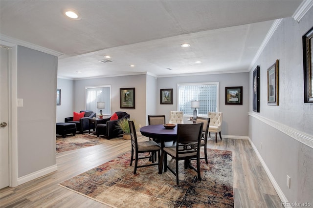 dining room featuring ornamental molding, recessed lighting, wood finished floors, and baseboards