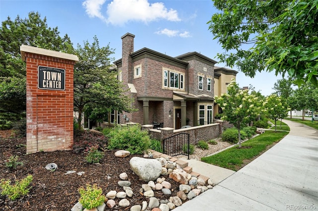 681 W Burgundy St Unit A, Highlands Ranch, CO 80129 - view of front of home featuring a chimney and brick siding