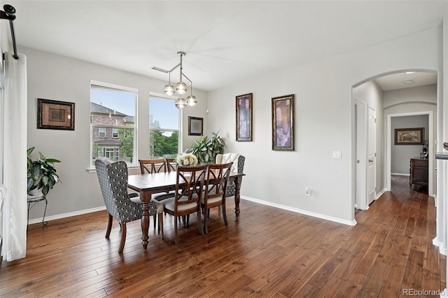 681 W Burgundy St Unit A, Highlands Ranch, CO 80129 - dining space featuring arched walkways, dark wood-style flooring, baseboards, and a chandelier