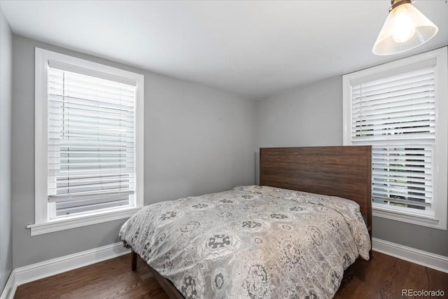 bedroom with dark hardwood / wood-style flooring