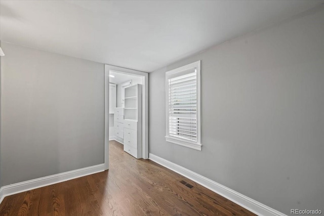 empty room with wood-type flooring