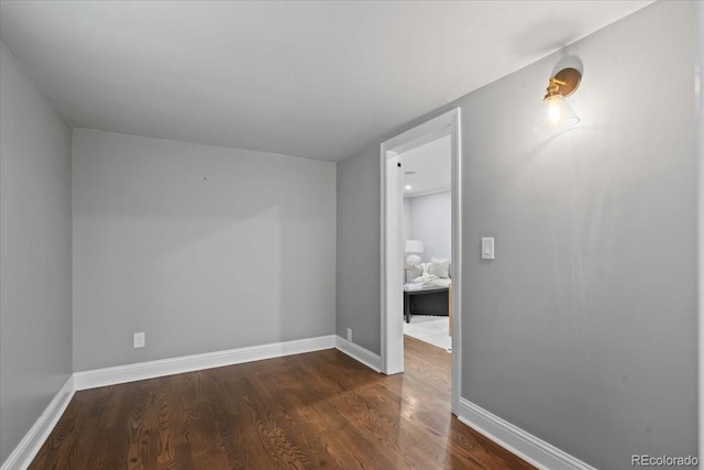 empty room featuring dark hardwood / wood-style flooring