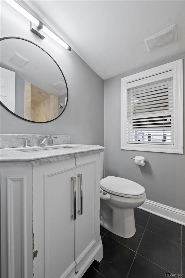 bathroom featuring vanity, tile patterned floors, and toilet