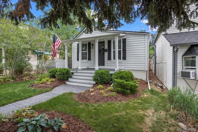 bungalow-style house featuring a front yard and covered porch