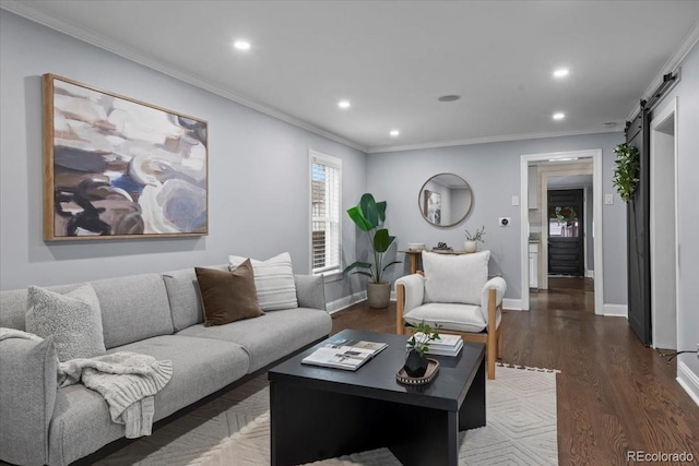 living room featuring ornamental molding, a barn door, and dark hardwood / wood-style flooring