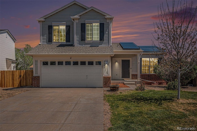 3543 S Ceylon Way, Aurora, CO 80013 - traditional home featuring solar panels, an attached garage, brick siding, and driveway