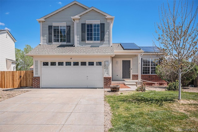 3543 S Ceylon Way, Aurora, CO 80013 - traditional home with brick siding, an attached garage, roof mounted solar panels, driveway, and roof with shingles