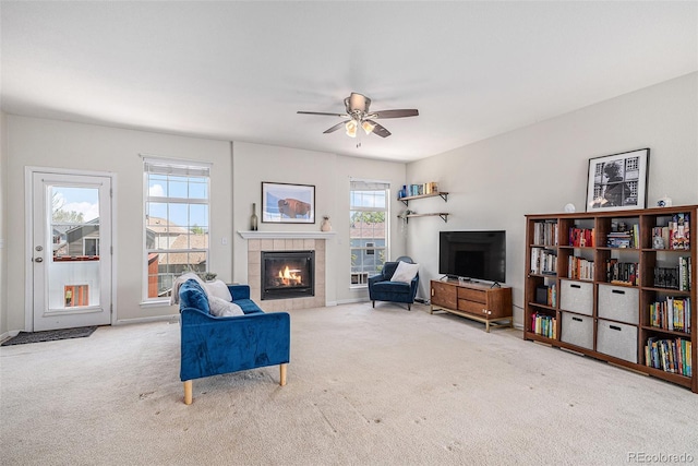 3543 S Ceylon Way, Aurora, CO 80013 - living area featuring a tiled fireplace, carpet, and ceiling fan