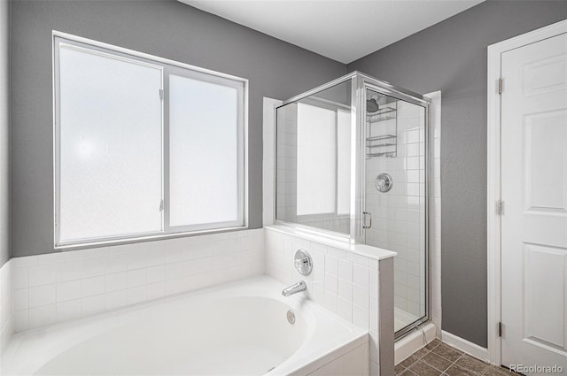 3543 S Ceylon Way, Aurora, CO 80013 - full bath with a stall shower, a garden tub, tile patterned floors, and baseboards