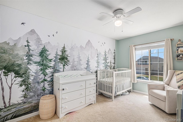 3543 S Ceylon Way, Aurora, CO 80013 - carpeted bedroom with a crib, a ceiling fan, and baseboards