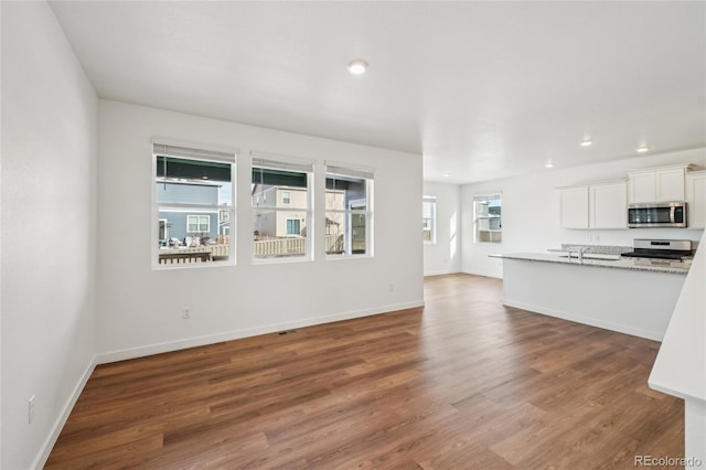 unfurnished living room with dark wood-type flooring