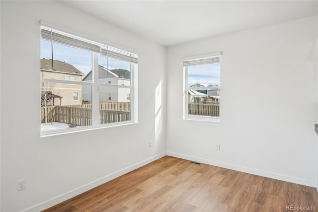 unfurnished room with light wood-type flooring