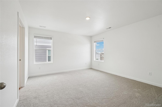 spare room featuring light colored carpet