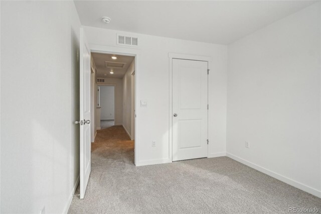 unfurnished bedroom with light colored carpet