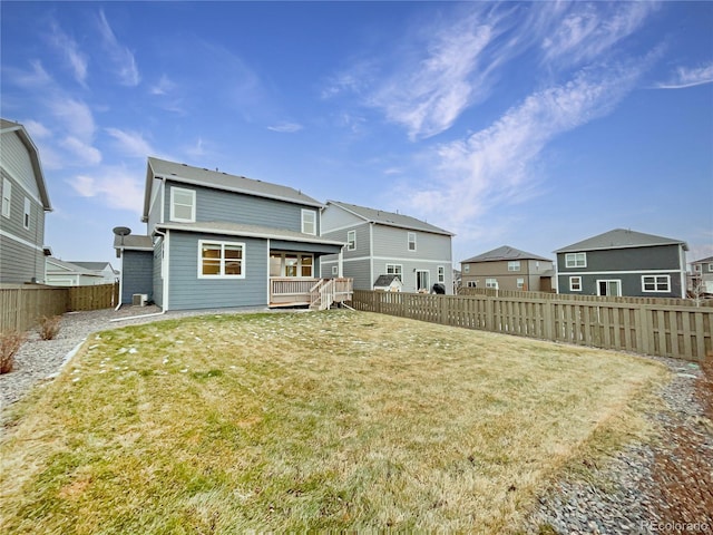 back of house with a lawn