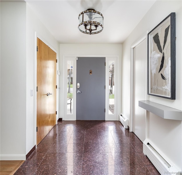 entryway with baseboards, a chandelier, a baseboard heating unit, and granite finish floor
